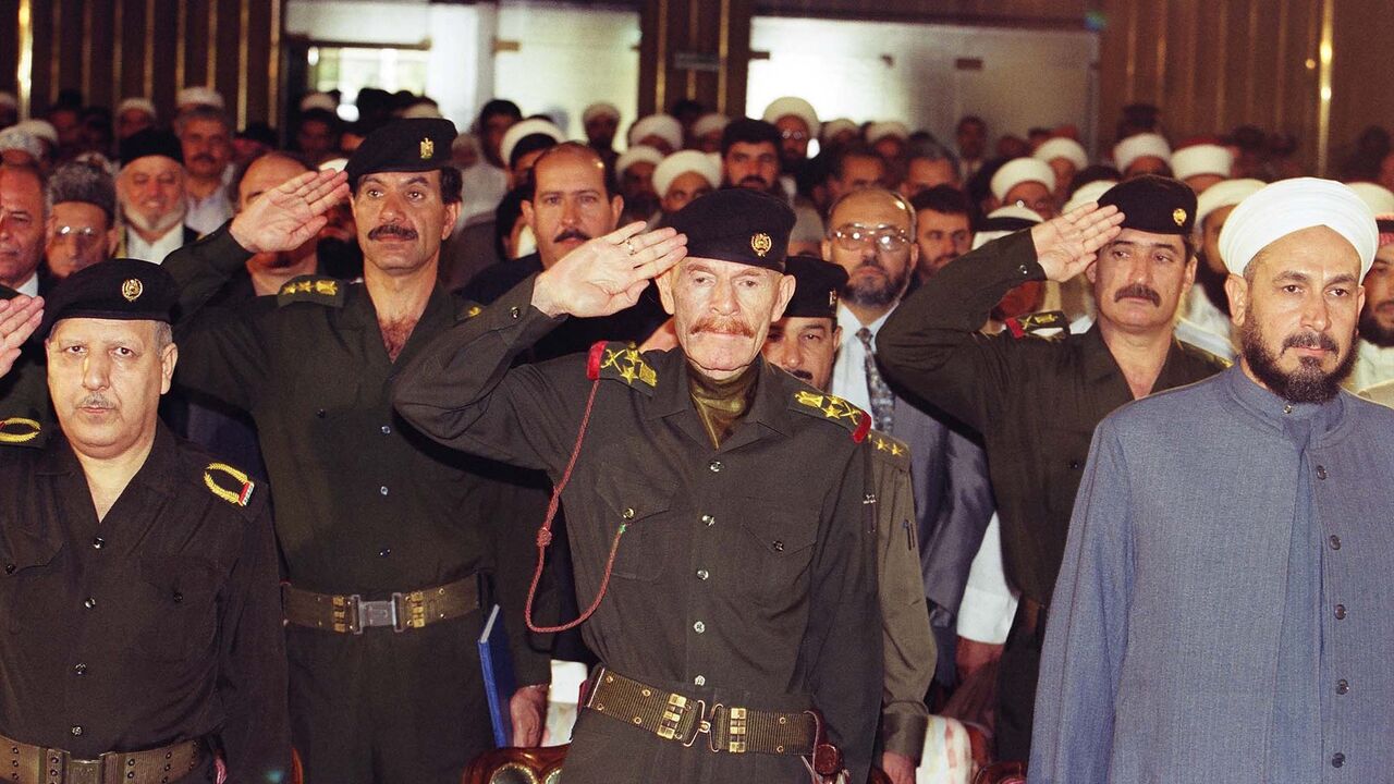57193354 BAGHDAD, IRAQ - UNDATED: (FILE PHOTO) Former former Baath official and deputy to deposed Iraqi president Saddam Hussein, Izzat Ibrahim al-Douri (C) is shown in this 1999 photograph in Baghdad, Iraq. Arab television network Al Jazeera played an audio tape March 27, 2006 purportedly from al-Douri, in which he urges Arab leaders to boycott Iraq's government and recognizes the resistance. (Photo by Salah Malkawi/Getty Images)