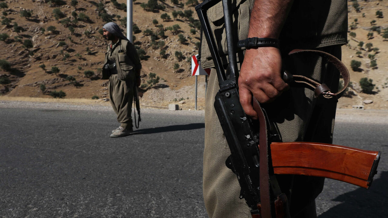 981444966 A member of the Kurdistan Workers' Party (PKK) carries an automatic rifle on a road in the Qandil Mountains, the PKK headquarters in northern Iraq, on June 22, 2018. - Hundreds of Iraqi Kurds marched Friday to protest Turkish strikes against the Kurdistan Workers' Party (PKK) after Turkey's President Recep Tayyip Erdogan said Ankara would press an operation against its bases. (Photo by SAFIN HAMED / AFP) (Photo credit should read SAFIN HAMED/AFP via Getty Images)