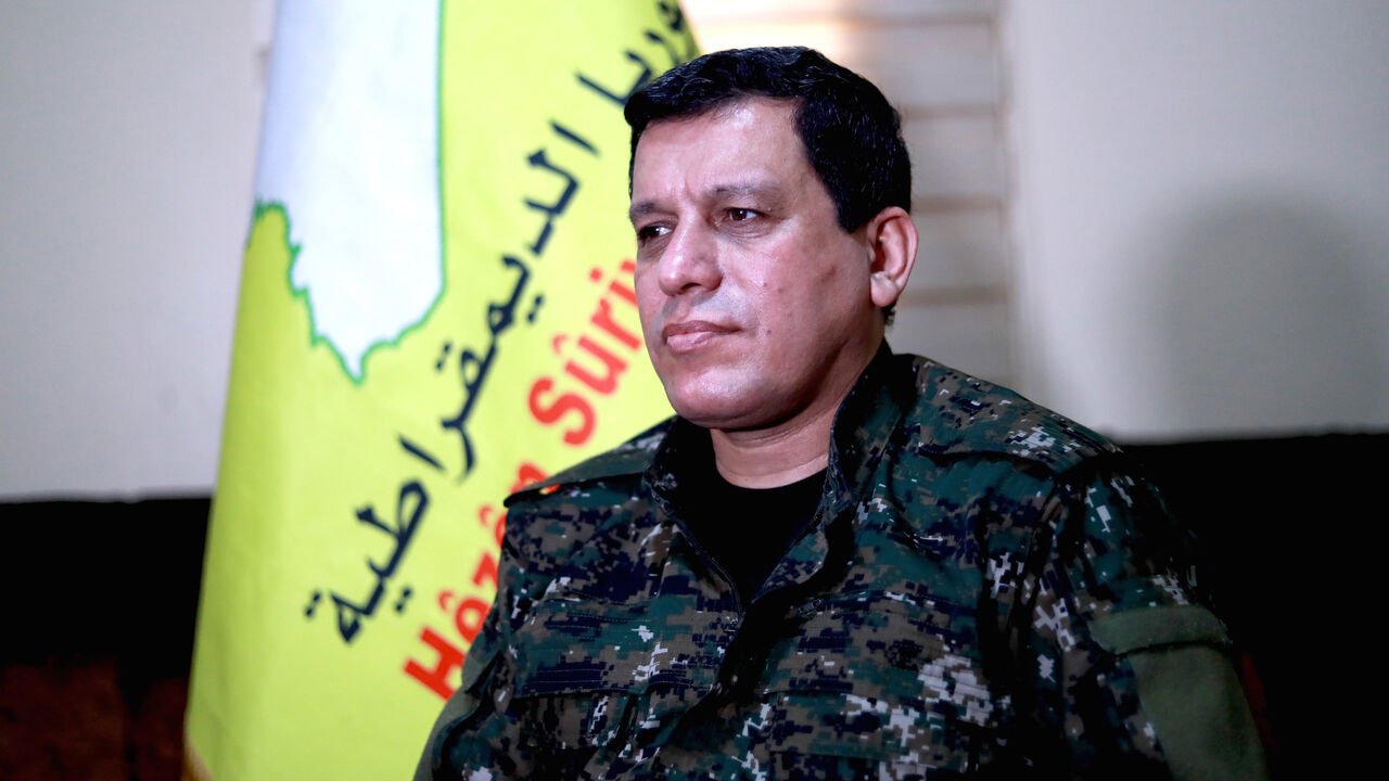 1088199214 Mazloum Abdi (Kobani), commander-in-chief of the Syrian Democratic Forces (SDF), speaks with AFP during an interview in the countryside outside the northwestern Syrian city of Hasakah, in the province of the same name, on January 24, 2019. - Any deal between Syria's Kurds and the Damascus regime should respect the "special status" of Kurdish-led forces who fought the Islamic State (IS) group, Kobani said. The SDF control around a third of Syria after expelling jihadists from a large northeastern swathe of t