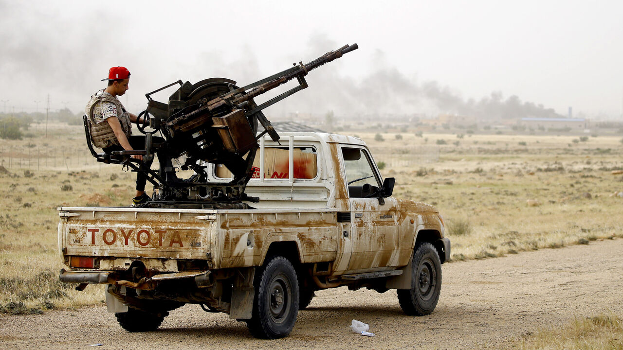 1138936589 Vehicles belonging to Libyan fighters loyal to the Government of National Accord (GNA) are pictured during clashes with forces loyal to strongman Khalifa Haftar in al-Hira region 70 km south of the capital Tripoli, on April 23, 2019. - At least 264 people have been killed and over 1,200 wounded in weeks of fighting on the outskirts of Libya's capital, the World Health Organization said Tuesday, as African leaders gathered in Cairo to discuss the crisis. (Photo by Mahmud TURKIA / AFP) (Photo credit sh