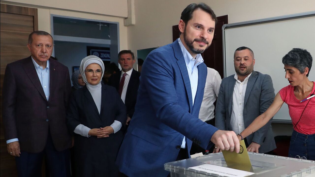 1151581454 Turkish Finance Minister Berat Albayrak (C) casts his ballot at a polling station on June 23, 2019, during the mayoral election re-run in Istanbul, next to Turkish President Recep Tayyip Erdogan (rear L) and his wife Emine (rear 2nd L). - Istanbul went back to the polls on June 23, 2019 in a re-run of the mayoral election that has become a test of Turkish democracy as well as Turkish President's continued popularity at a time of economic trouble. (Photo by Adem ALTAN / AFP) (Photo credit should read