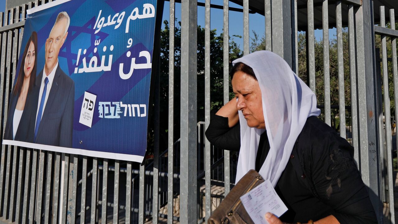1168768985 A member of the Israeli Druze community leaves after casting her vote during Israel's parliamentary elections on September 17, 2019, in Daliyat al-karmel in northern Israel. (Photo by JALAA MAREY / AFP) (Photo credit should read JALAA MAREY/AFP via Getty Images)