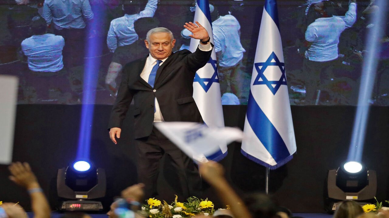 1168968643 Israeli Prime Minister Benjamin Netanyahu waves to supporters upon arrival at his Likud party's electoral campaign headquarters to give an address early on September 18, 2019. - Israeli Prime Minister Benjamin Netanyahu said he was waiting for results in the country's general election, but that he was prepared for negotiations to form a "strong Zionist government." He spoke as exit polls showed a tight race between his right-wing Likud and ex-military chief Benny Gantz's centrist Blue and White alliance. (P
