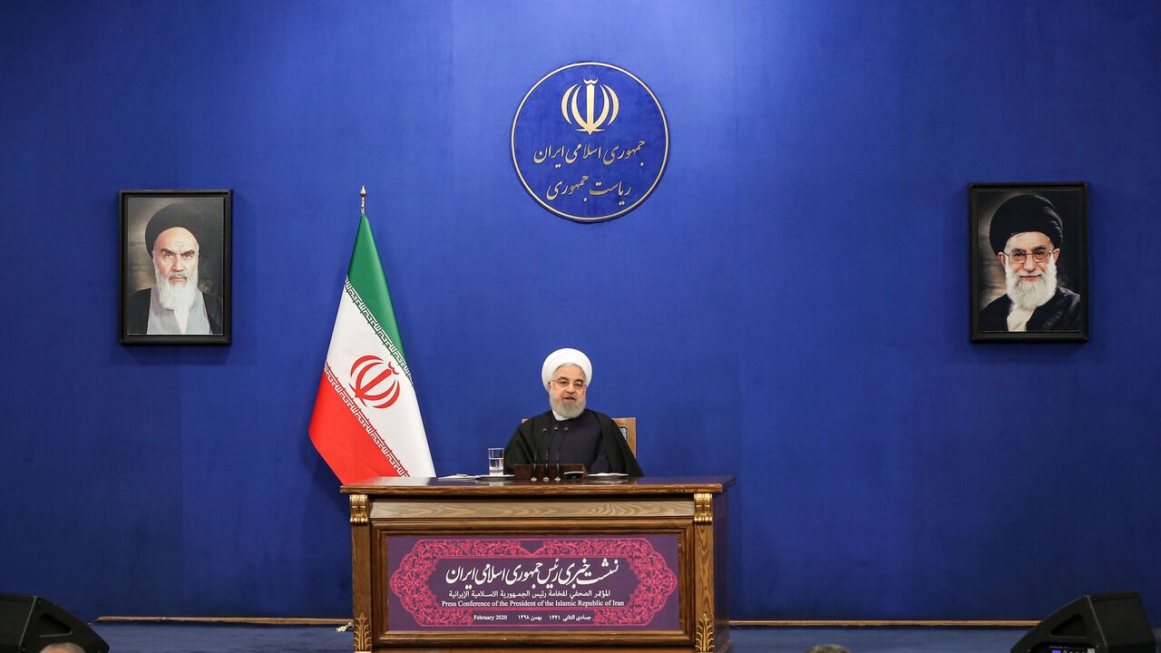 1201241910 Iranian President Hassan Rouhani speaks during a news conference in the capital Tehran, on February 16, 2020, with the portraits of Iran's (L to R) former and current Supreme Leaders, Ayatollah Ruhollah Khomeini and Ayatollah Ali Khamenei, seen behind. - Iran's President Hassan Rouhani ruled out resigning and vowed to see out his term, even as he admitted he had offered to step aside twice since being elected. Speaking ahead of a general election next Friday, Rouhani also appealed to voters to turn out desp