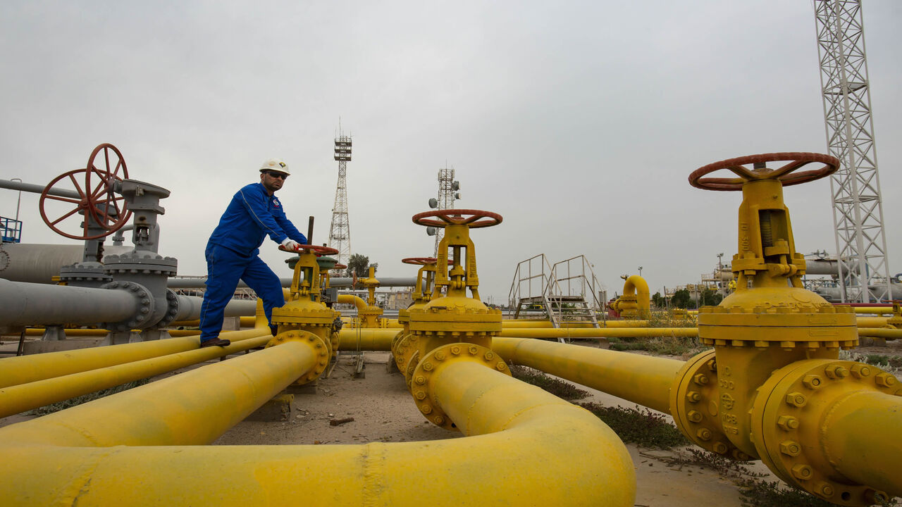 1210615115 An employee turns a valve at the Nahr Bin Omar natural gas field, north of the southern Iraqi port of Basra on April 21, 2020. (Photo by Hussein FALEH / AFP) (Photo by HUSSEIN FALEH/AFP via Getty Images)
