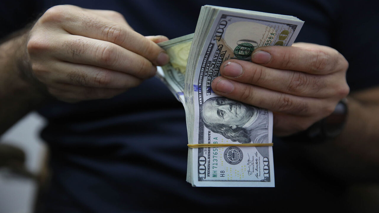 1212056405 A man counts a pile of US Dollar bank notes in the Iraqi capital Baghdad on May 4, 2020, during the novel coronavirus pandemic crisis. - With its financial outlook darkening by the day, Iraq is considering slashing its massive public payroll -- an unpopular move likely to renew protests.
OPEC's second-largest producer has been hit hard by the double-whammy of collapsed crude prices and the COVID-19 pandemic, which have hacked at its revenues from oil sales. (Photo by AHMAD AL-RUBAYE / AFP) (Photo by AHMAD A