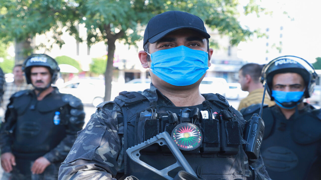 1221007616 Kurdish riot police, some wearing protective masks due to COVID-19, stand guard during a demonstration to denounce the Turkish assault in northern Iraq, in Sulaimaniyah city, in the Kurdish autonomous region of northern Iraq, on June 18, 2020. - Turkey launched a rare ground assault into northern Iraq on June 17, deploying special forces against rebels from the Kurdistan Workers' Party (PKK) which is blacklisted by Ankara as a "terrorist" group. Baghdad demanded Ankara immediately halt its assault in northe
