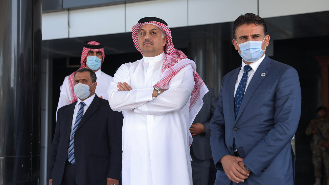 1228078842 Qatari Defense Minister Khalid bin Muhammad al-Attiah (C) waits for the arrival of his Turkish counterpart to meet with Prime Minister of Libya's UN-recognised Government of National Accord (GNA) Fayez al-Sarraj (unseen) in the capital Tripoli, on August 17, 2020. (Photo by - / AFP) (Photo by -/AFP via Getty Images)
