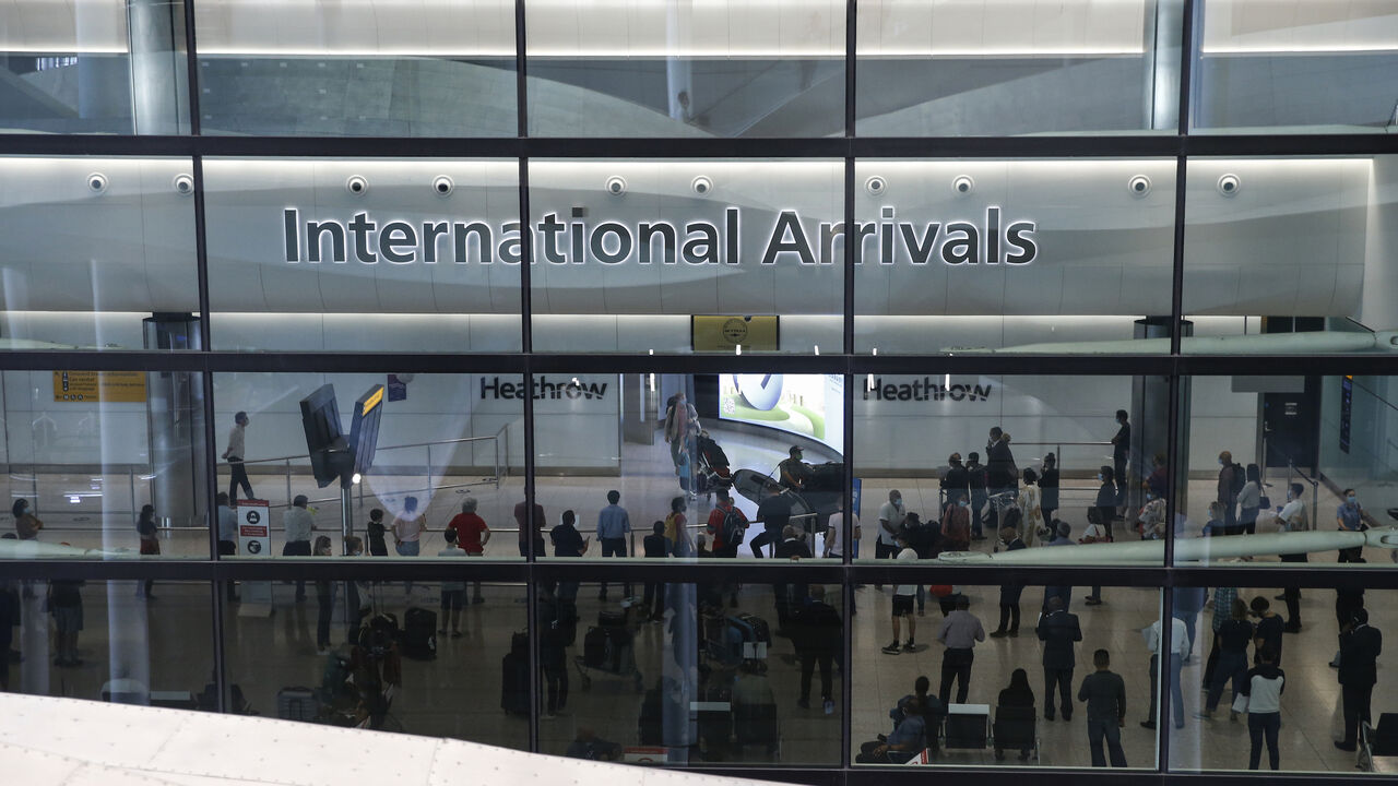 1228151686 LONDON, ENGLAND - AUGUST 22: Travellers exit via the International Arrival gate at Heathrow Airport Terminal 2 on August 22, 2020 in London, England. As of Saturday morning at 4am, travellers arriving in England from Austria, Croatia, and Trinidad and Tobago were required to quarantine themselves for 14 days. At the same time, travellers from Portugal were no longer required to quarantine. (Photo by Hollie Adams/Getty Images)