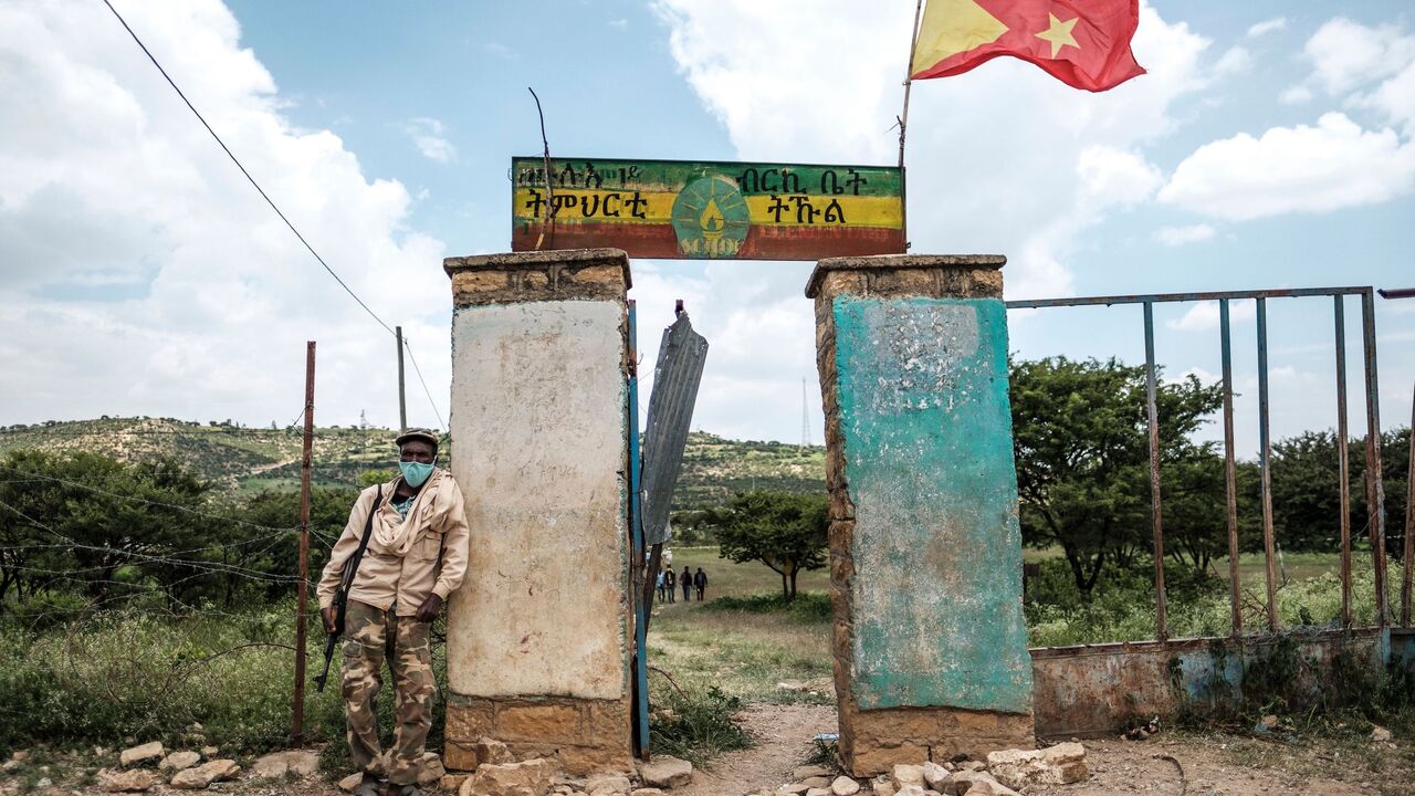 1228421349 TOPSHOT - An armed member of the community security stands in front of a school where a polling station is located during Tigrays regional elections, in the town of Tikul, 15 kms east from Mekele, Ethiopia, on September 9, 2020. - Ethiopia's northern Tigray region vote on September 9, 2020 in parliamentary elections that Prime Minister Abiy Ahmed's government has deemed illegal.
Polls opened at 6am (0300 GMT) across the mountainous northern Tigray region despite a federal decision to postpone all elections