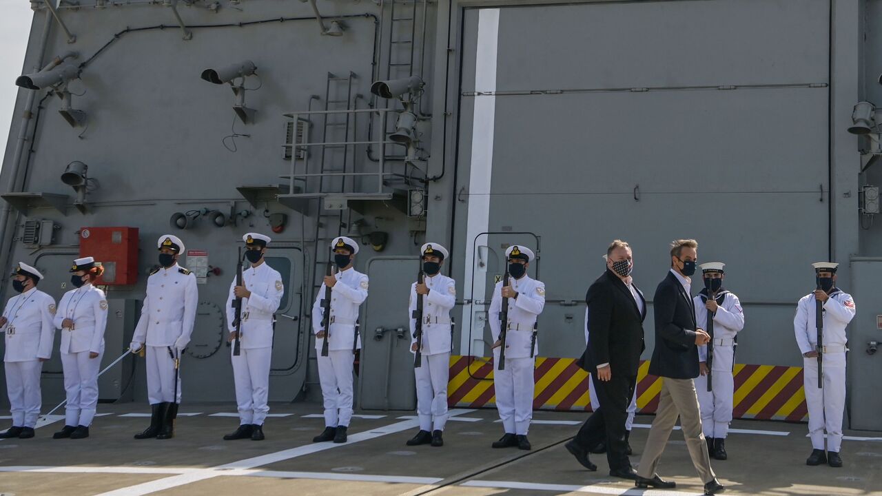 1228781323 US Secretary of State Mike Pompeo (C-L) and Greek Prime Minister Kyriakos Mitsotakis visit the Greek Naval frigate Salamis during their visit to the Naval Support Activity base at Souda, the foremost US naval facility in the eastern Mediterranean on the Greek island of Crete. - US Secretary of State Mike Pompeo on September 29, 2020, concludes a two-day visit to Greece on with a tour of a strategically vital NATO base on a trip aimed at easing tensions between Greece and Turkey in the eastern Mediterranean.