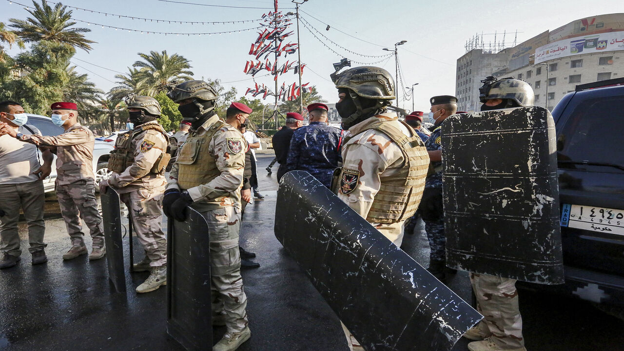 1229370260 Members of the Iraqi security forces stand guard during the reopening of the Iraqi capital Baghdad's central Tahrir Square on October 31, 2020. - Iraqi authorities reopened Tahrir Square in central Baghdad, in a sign of easing tensions a year after the launch of an anti-government protest movement. Protests demanding a total overhaul of the ruling class lost momentum then ground to a halt in the spring due to the coronavirus crisis and rising US-Iran tensions. (Photo by Sabah ARAR / AFP) (Photo by SABAH ARA