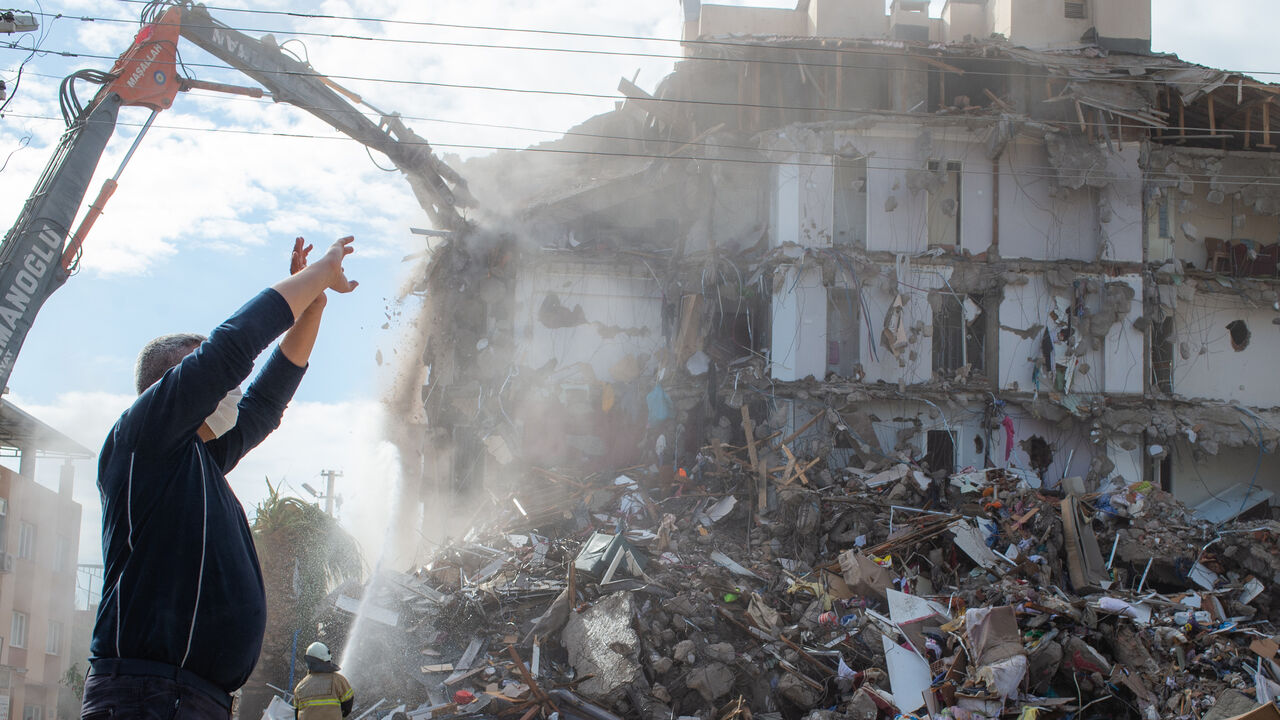 1229415071 A firefighter watches as a damaged building is demolished in a controlled manner during the ongoing search operation for survivors and victims at the site of a collapsed building in the city of Izmir on November 2, 2020, after a powerful earthquake struck Turkey's western coast and parts of Greece. - Rescue workers were searching eight buildings in Izmir despite dwindling hope for survivors, as the death toll of a powerful magnitude earthquake which hit western Turkey rose to 69. The 7.0-magnitude quake has