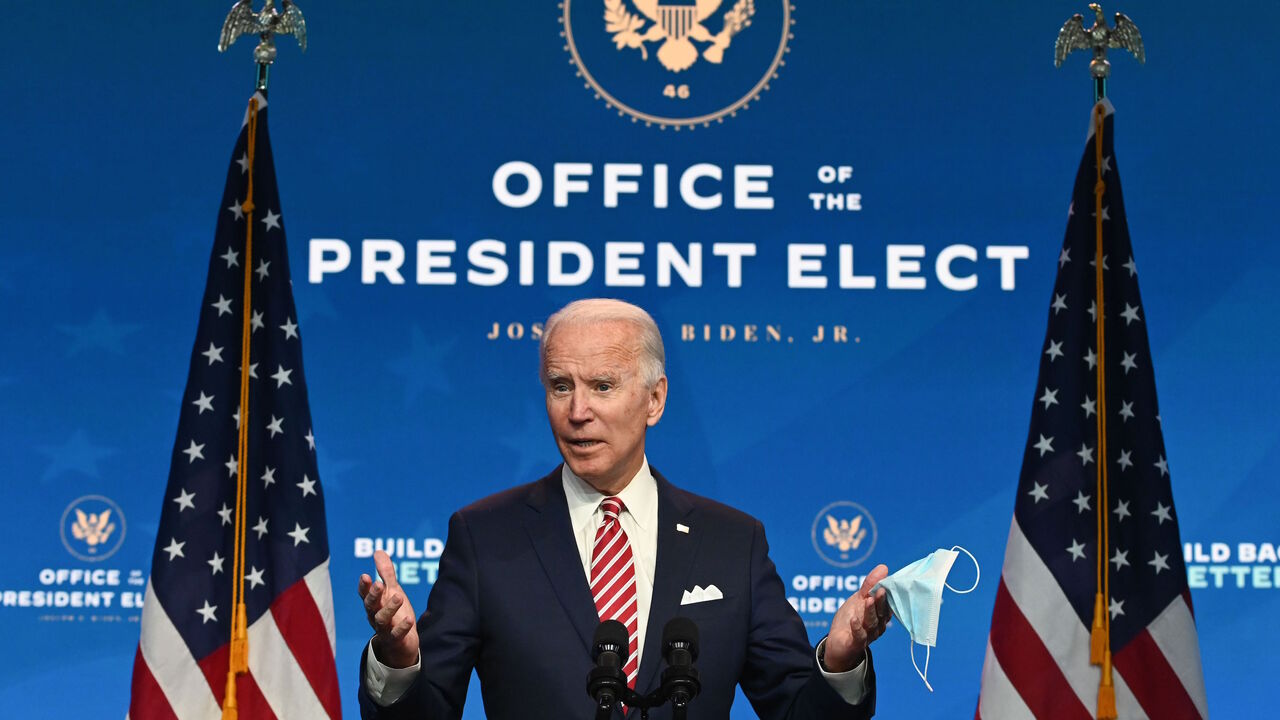1229645503 US President-elect Joe Biden shows a face mask as he answers questions about COVID 19 from the press at The Queen in Wilmington, Delaware on November 16, 2020. - US President-elect Joe Biden expressed frustration on November 16, 2020 about Donald Trump's refusal so far to cooperate on the White House transition process, saying "more people may die" without immediate coordination on fighting the coronavirus pandemic. (Photo by ROBERTO SCHMIDT / AFP) (Photo by ROBERTO SCHMIDT/AFP via Getty Images)