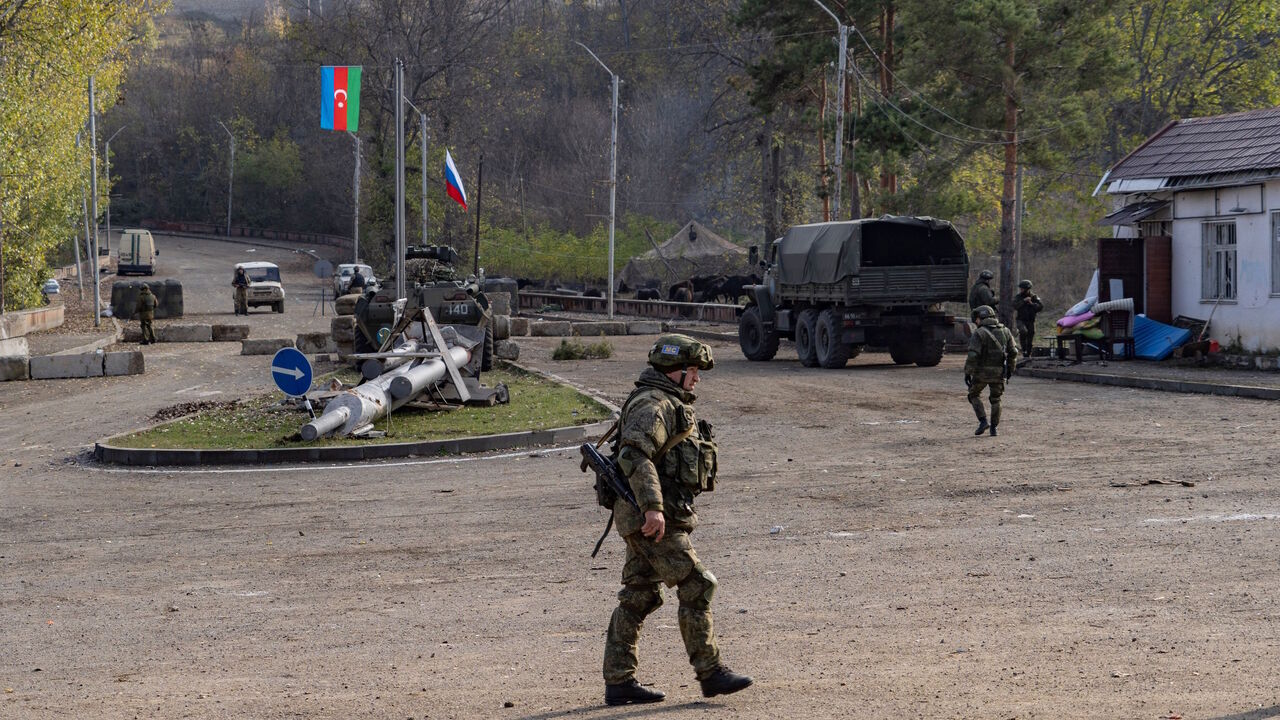 Russian peacekeepers patrol at a checkpoint near Shusha along the Goris-Stepanakert road on November 17, 2020. - The first civilians are driving through the six-kilometre Lachin corridor, which is Armenias sole land link with Nagorno-Karabakh following the Moscow-brokered peace deal that ended six weeks of fierce fighting over the disputed region. Safe passage of people and goods is ensured by Russian peacekeepers. (Photo by Andrey BORODULIN / AFP) (Photo by ANDREY BORODULIN/AFP via Getty Images)