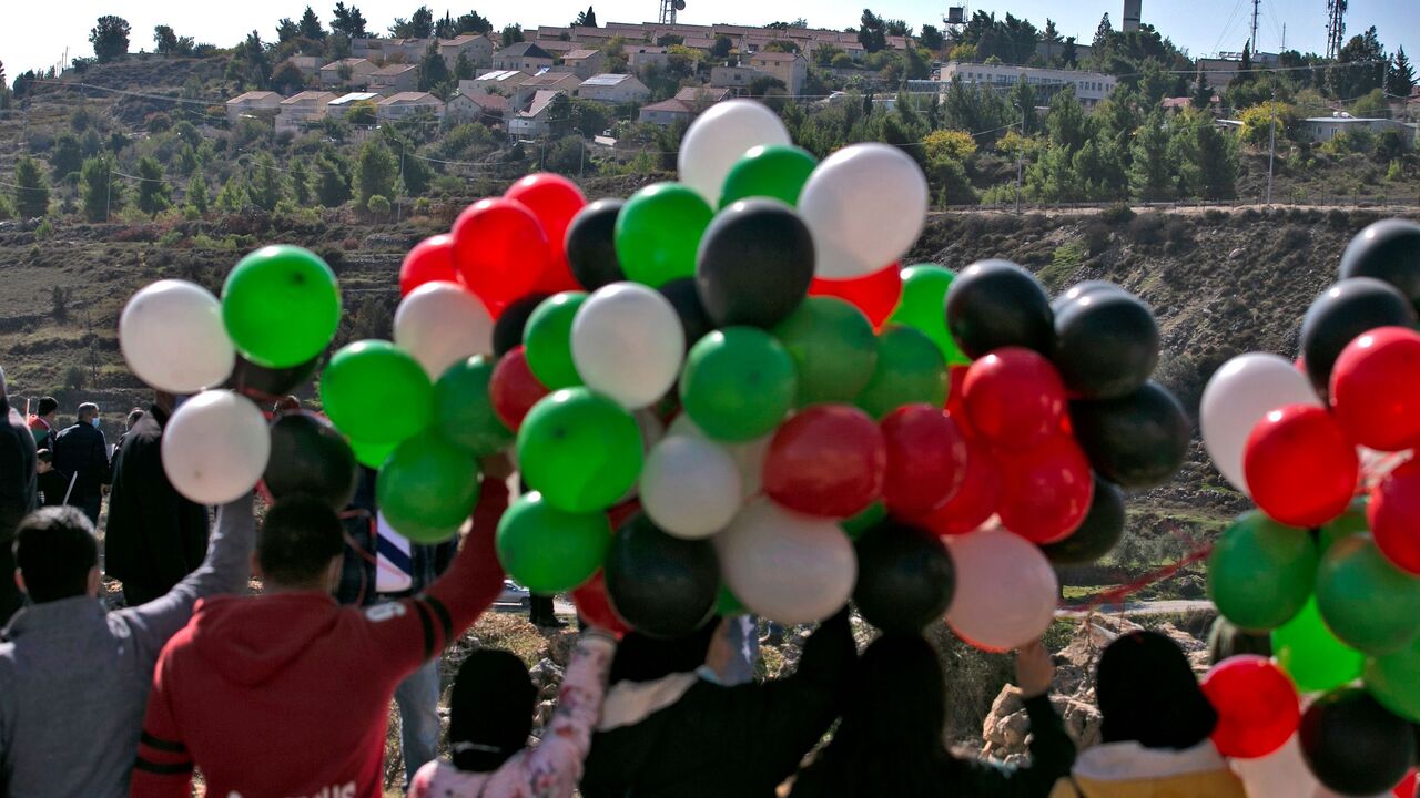 1229664188 Palestinians demonstrate near the Israeli settlement of Psagot, built on the lands of the city of al-Bireh, against the visit by US Secretary of State's to the settlement, on November 18, 2020 in the occupied West Bank. - US Secretary of State Mike Pompeo was due to arrive in Jerusalem today for a farewell visit as the chief diplomat of the strongly pro-Israeli Trump administration. (Photo by ABBAS MOMANI / AFP) (Photo by ABBAS MOMANI/AFP via Getty Images)