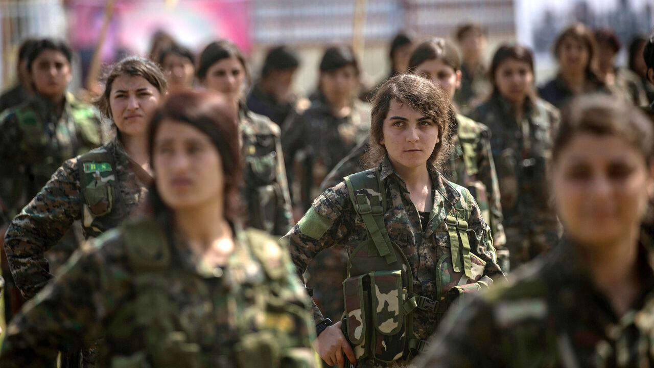 1133149058 Fighters from the Kurdish Women's Protection units (YPJ) participate in a military parade on March 27, 2019, celebrating the total elimination of the Islamic State (IS) group's last bastion in eastern Syria, in the northwestern city of Hasakah, in the province of the same name. (Photo by Delil SOULEIMAN / AFP) (Photo credit should read DELIL SOULEIMAN/AFP via Getty Images)
