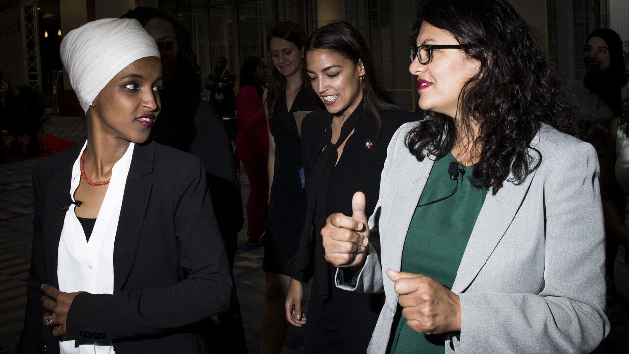 1167449538 WASHINGTON, DC - SEPTEMBER 11: Rep. Ilhan Omar (D-MN), Rep. Alexandria Ocasio-Cortez (D-NY, and Rep. Rashida Tlaib (D-MI) arrive before participating during a town hall hosted by the NAACP on September 11, 2019 in Washington, DC. Also pictured is CNN Commentator Angela Rye. (Photo by Zach Gibson/Getty Images)