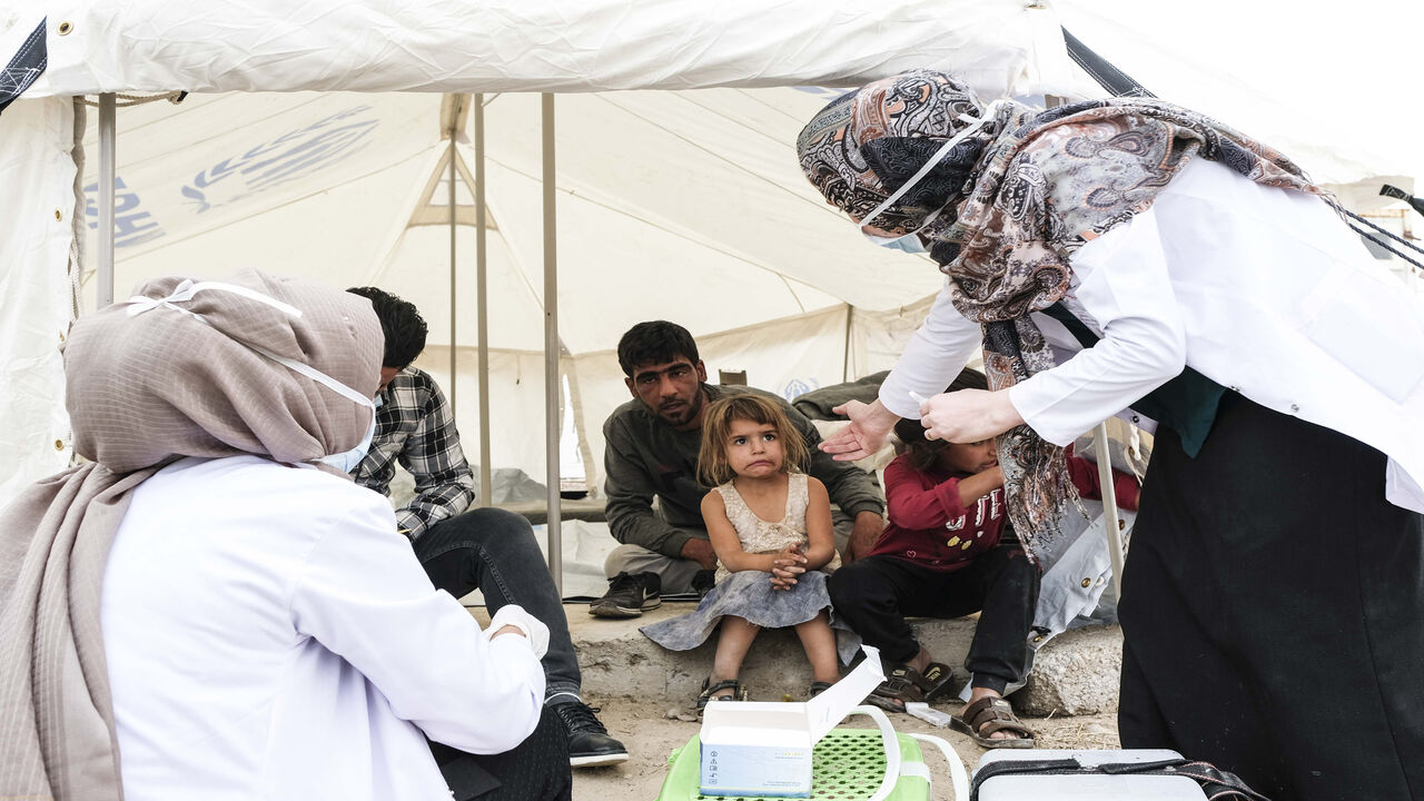 1176336744 DOHUK, IRAQ - OCTOBER 17: Syrian refugees children who fled the Turkish incursion in Northern Syria receive medicine for polio and measles as more than 200 arrive at the facility on October 17, 2019 in Dohuk, Iraq. More than 1000 refugees have arrived in Northern Iraq since the beginning of the conflict, with many saying they paid to be smuggled through the Syrian border. (Photo by Byron Smith/Getty Images)