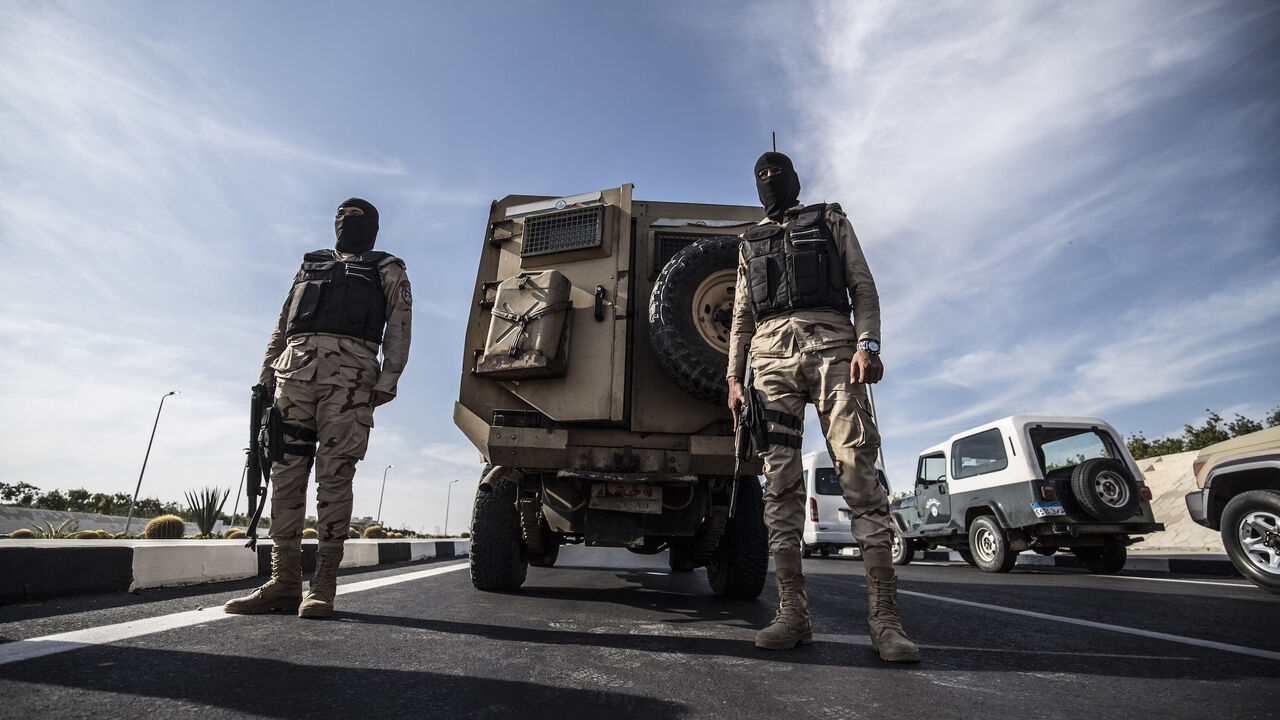 1183028424 Egyptian soldiers stand guard during an organised tour for diplomats to mark the 150th anniversary of the inauguration of the Suez Canal, in the northeastern city of Ismailia on November 17, 2019. - One hundred and fifty years after the Suez Canal opened, the international waterway is hugely significant to the economy of modern-day Egypt, which nationalised it in 1956. The canal, dug in the 19th century using "rudimentary tools" and which links the Mediterranean to the Red Sea, was opened to navigation in 1