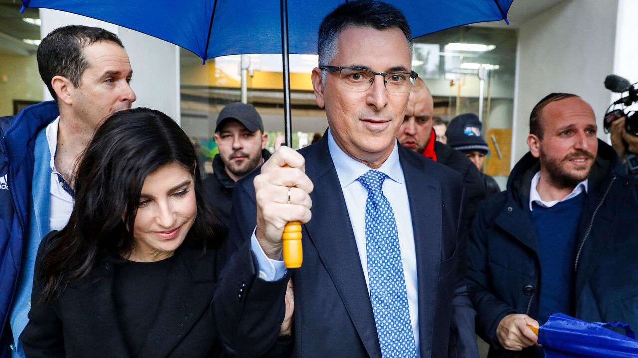 1190486988 Gideon Saar (C), Israeli Member of Knesset for Likud, accompanied by his wife Geula Even Saar (L), leave a polling station after casting his ballot during a primary election vote to elect the party chairman, in the coastal city of Tel Aviv, on December 26, 2019. - Saar is the only challenger for incumbent Prime Minister Benjamin Netanyahu for the Likud party leadership ahead of the scheduled general elections in 2020. (Photo by JACK GUEZ / AFP) (Photo by JACK GUEZ/AFP via Getty Images)