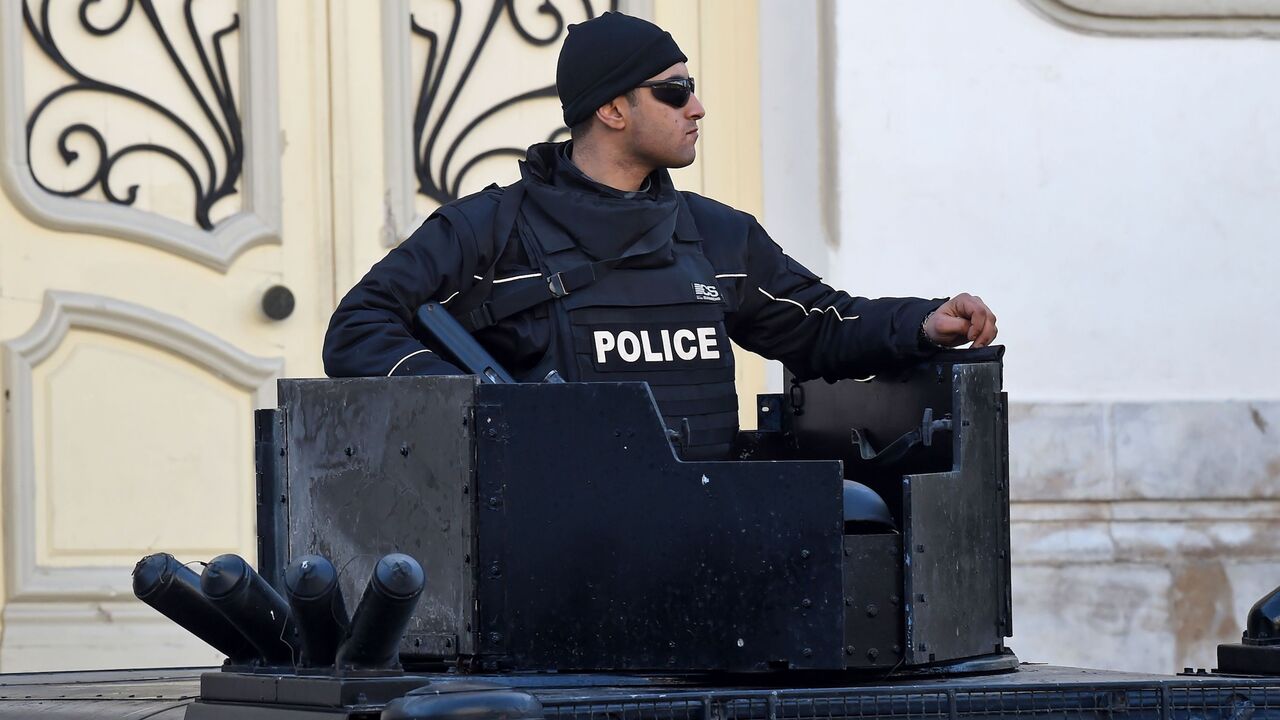 1193604526 A Tunisian policeman stands guard in central Tunis during a rally marking the ninth anniversary of the 2011 uprising on Habib Bourguiba Avenue on January 14, 2020. (Photo by FETHI BELAID / AFP) (Photo by FETHI BELAID/AFP via Getty Images)