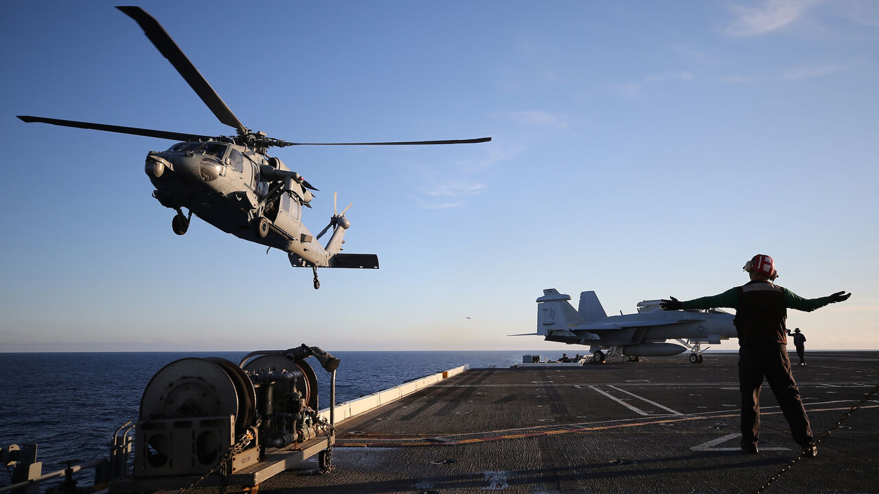 1200800558 AT SEA - JANUARY 18: A U.S. Navy helicopter descends to land on the flight deck of the USS Nimitz (CVN 68) aircraft carrier while at sea on January 18, 2020 off the coast of Baja California, Mexico. The USS Nimitz is currently conducting routine operations and training at sea. The nuclear-powered aircraft carrier holds a flight deck area of 4.5 acres and can hold 65 aircraft along with nearly 5,000 total personnel. It is the oldest U.S. Navy carrier in active service and was commissioned on May 3, 1975. (Ph