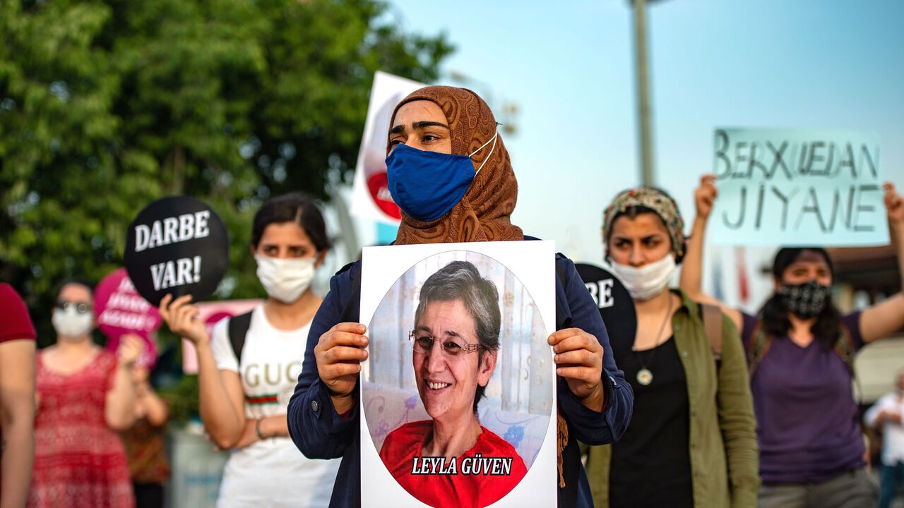 1218016077 A demonstrator holds a picture of HDP lawmaker Leyla Guven during a protest against the detention of three opposition lawmakers, in Istanbul, Turkey, on June 6, 2020. - Turkish police on June 4, 2020 detained three opposition lawmakers after the parliament stripped them of their jobs, triggering furious charges that President Recep Tayyip Erdogan's government is seeking to further consolidate authoritarian rule. (Photo by Yasin AKGUL / AFP) (Photo by YASIN AKGUL/AFP via Getty Images)