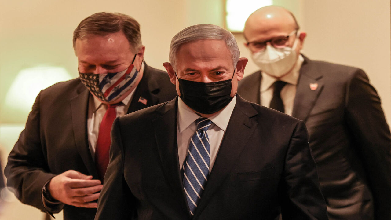 1229668695 (L to R) US Secretary of State Mike Pompeo, Israeli Prime Minister Benjamin Netanyahu, and Bahrain's Foreign Minister Abdullatif bin Rashid Al Zayani, all mask-clad due to the COVID-19 coronavirus pandemic, arrive for a press conference after their trilateral meeting in Jerusalem on November 18, 2020. (Photo by Menahem KAHANA / POOL / AFP) (Photo by MENAHEM KAHANA/POOL/AFP via Getty Images)