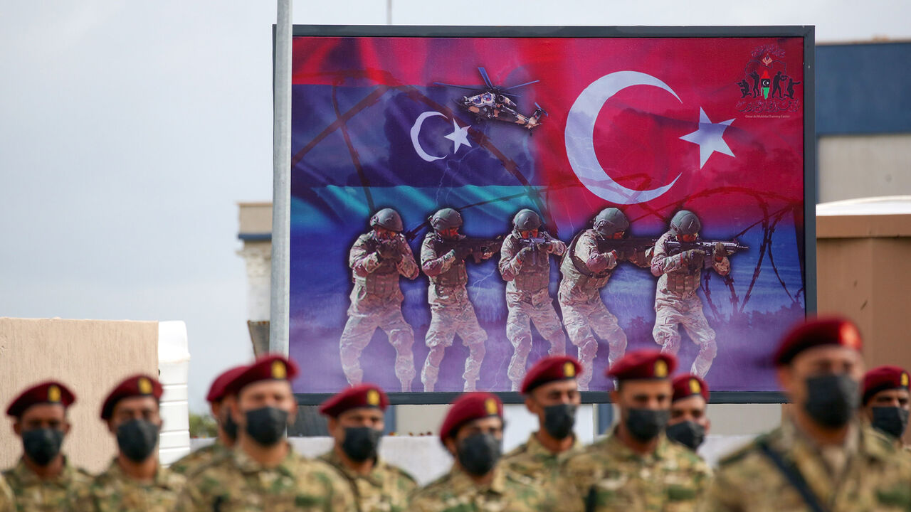 1229708467 Libyan military graduates loyal to the UN-recognised Government of National Accord (GNA) take part in a parade marking their graduation, a result of a military training agreement with Turkey, at the Omar Mukhtar camp in the city of Tajoura, southeast of the capital Tripoli on November 21, 2020. (Photo by Mahmud TURKIA / AFP) (Photo by MAHMUD TURKIA/AFP via Getty Images)