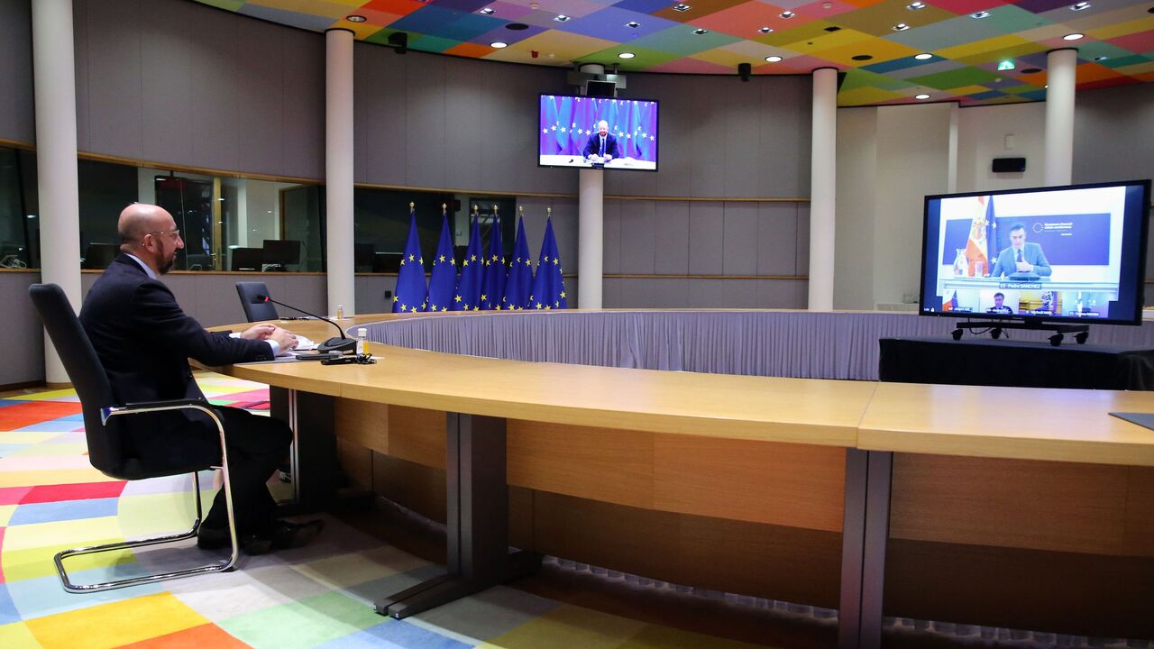 1229920990 European Council President Charles Michel speaks with Spanish Prime Minister Pedro Sanchez (on screen) as he attends a video conference with representatives of EU member states ahead of the upcoming EU summit, in Brussels, on December 3, 2020. - The summit will take place on December 10, 2020. (Photo by François WALSCHAERTS / POOL / AFP) (Photo by FRANCOIS WALSCHAERTS/POOL/AFP via Getty Images)