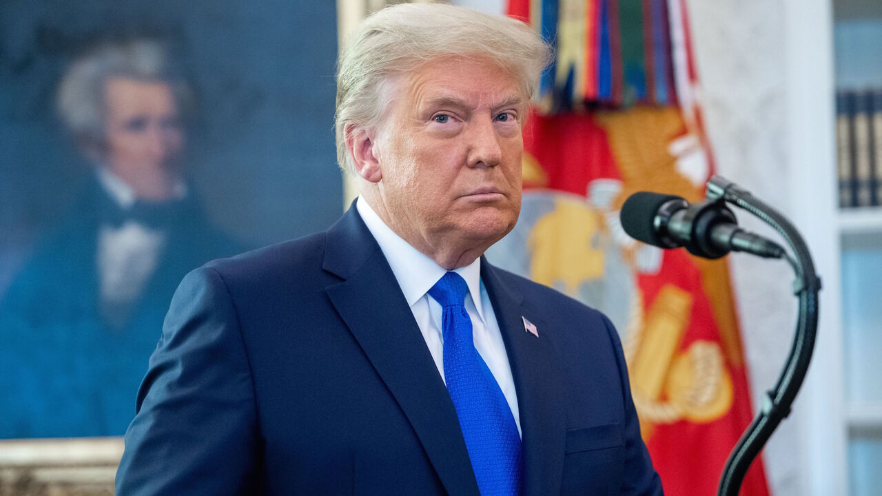 1229999067 TOPSHOT - US President Donald Trump looks on during a ceremony presenting the Presidential Medal of Freedom to wrestler Dan Gable in the Oval Office of the White House in Washington, DC on December 7, 2020. (Photo by SAUL LOEB / AFP) (Photo by SAUL LOEB/AFP via Getty Images)