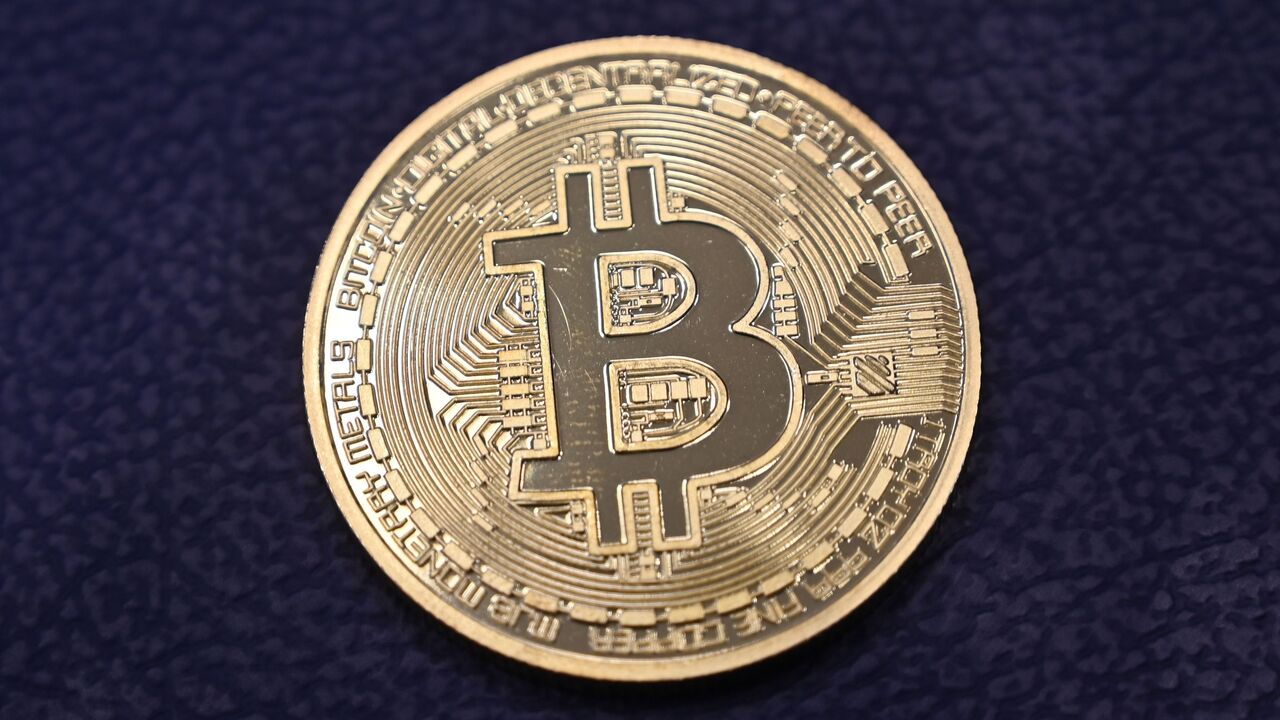 1230175462 This photograph taken on December 17, 2020 shows shows a physical imitation of a Bitcoin at a crypto currency "Bitcoin Change" shop, near Grand Bazaar, in Istanbul. - Leading virtual currency bitcoin on 16 December traded above $20,000 for the first time following a sustained run higher in recent weeks. Bitcoin reached a record-high $20,398.50 before pulling back to $20,145, which was still an intra-day gain of nearly four percent. (Photo by Ozan KOSE / AFP) (Photo by OZAN KOSE/AFP via Getty Images)