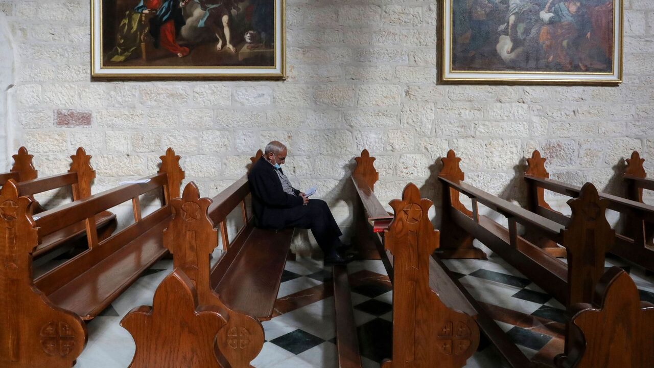 1230229126 A man is pictured in the Church of the Nativity, in the West Bank city of Bethlehem, on December 20, 2020 after it was re-opened for prayers following strict COVID-19 restrtictions. (Photo by HAZEM BADER / AFP) (Photo by HAZEM BADER/AFP via Getty Images)