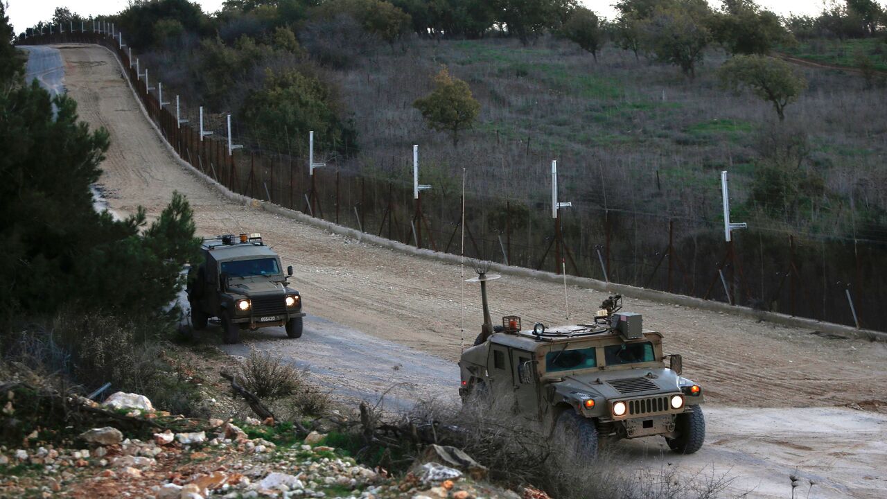 1230241593 Israeli military vehicles near the kibbutz Manara in northern Israel's upper Galilee patrol along the border with Lebanon overlooking the Hula Valley, on December 20, 2020. (Photo by JALAA MAREY / AFP) (Photo by JALAA MAREY/AFP via Getty Images)