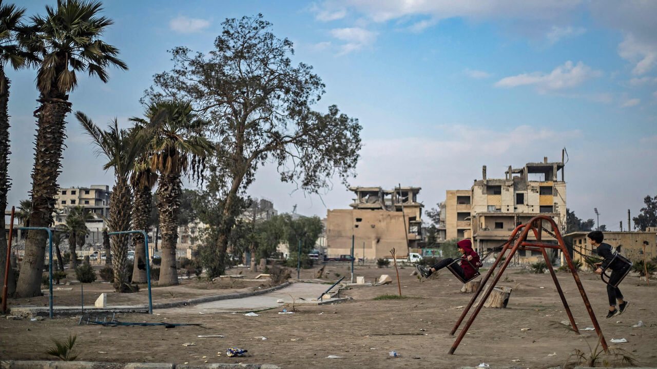 1230242178 TOPSHOT - Boys play on the swings in the northern Syrian city of Raqa, the former Syrian capital of the Islamic State (IS) group, on December 20, 2020. - The Kurdish-led Syrian Democratic Forces overran Raqa in 2017, after years of what residents described as IS's brutal rule, which included public beheading and crucifixions. (Photo by Delil SOULEIMAN / AFP) (Photo by DELIL SOULEIMAN/AFP via Getty Images)