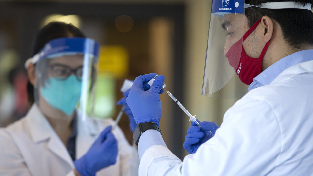 1230336027 KIRKLAND, WA - DECEMBER 28: Pharmacists prepare doses of COVID-19 vaccines at the Life Care Center of Kirkland on December 28, 2020 in Kirkland, Washington. The Life Care Center of Kirkland, a nursing home, was an early epicenter for coronavirus outbreaks in the U.S. (Photo by Karen Ducey/Getty Images)