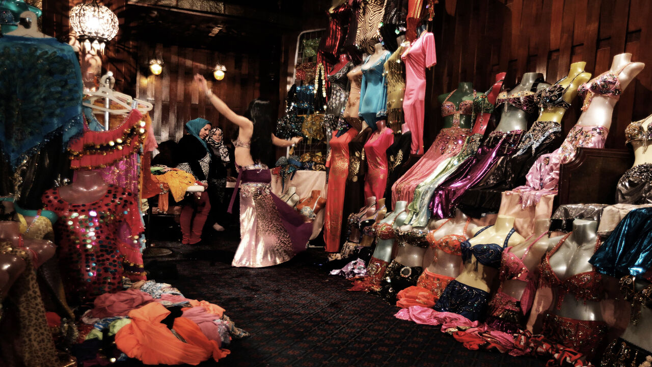 158601133 A Chinese dancer warms up before performing at a belly dancing school in the Egyptian capital Cairo on December 12, 2012. This picture was taken during a belly dancing festival with international performers from China, Russia, Lebanon, Tunisia and Britain. The festival organisers said they had received phone threats during the event, while some people, dreading the rise of Islamists to power, have expressed concern over restrictions to public freedoms posing a threat to Egypt's national dance. AFP PHOTO/PAT