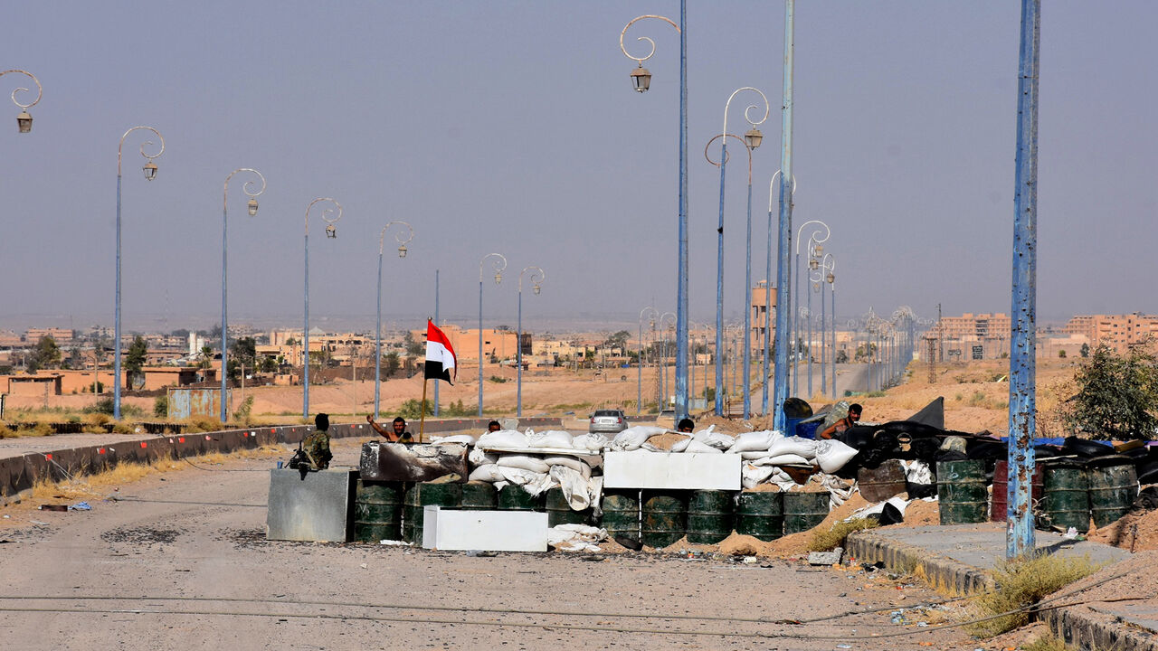 845325352 Members of the Syrian government forces stand guard at a checkpoint on the outskirts of Deir Ezzor on September 10, 2017, as they continue to press forward with Russian air cover in the offensive against Islamic State group jihadists across Deir Ezzor province. / AFP PHOTO / George OURFALIAN (Photo credit should read GEORGE OURFALIAN/AFP via Getty Images)