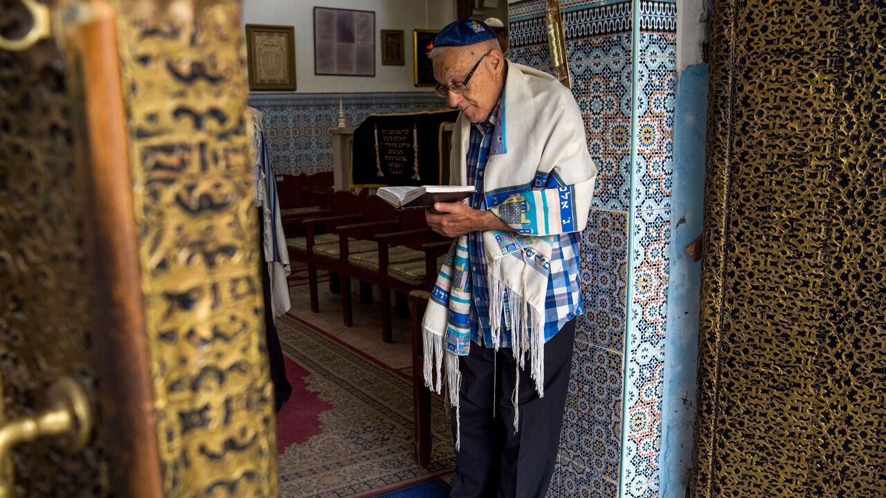 868332978 Moroccan Jews and Israeli Jewish tourists participate in a religious ceremony to observe the holiday of Sukkot (the Feast of the Tabernacles) at a synagogue in the "Mellah" Jewish quarter of the Medina in Marrakesh on October 13, 2017.
The once teeming Jewish area of Moroccan tourist gem Marrakesh is seeing its fortunes revived as visitors including many from Israel flock to experience its unique culture and history. / AFP PHOTO / FADEL SENNA (Photo credit should read FADEL SENNA/AFP via Getty Images