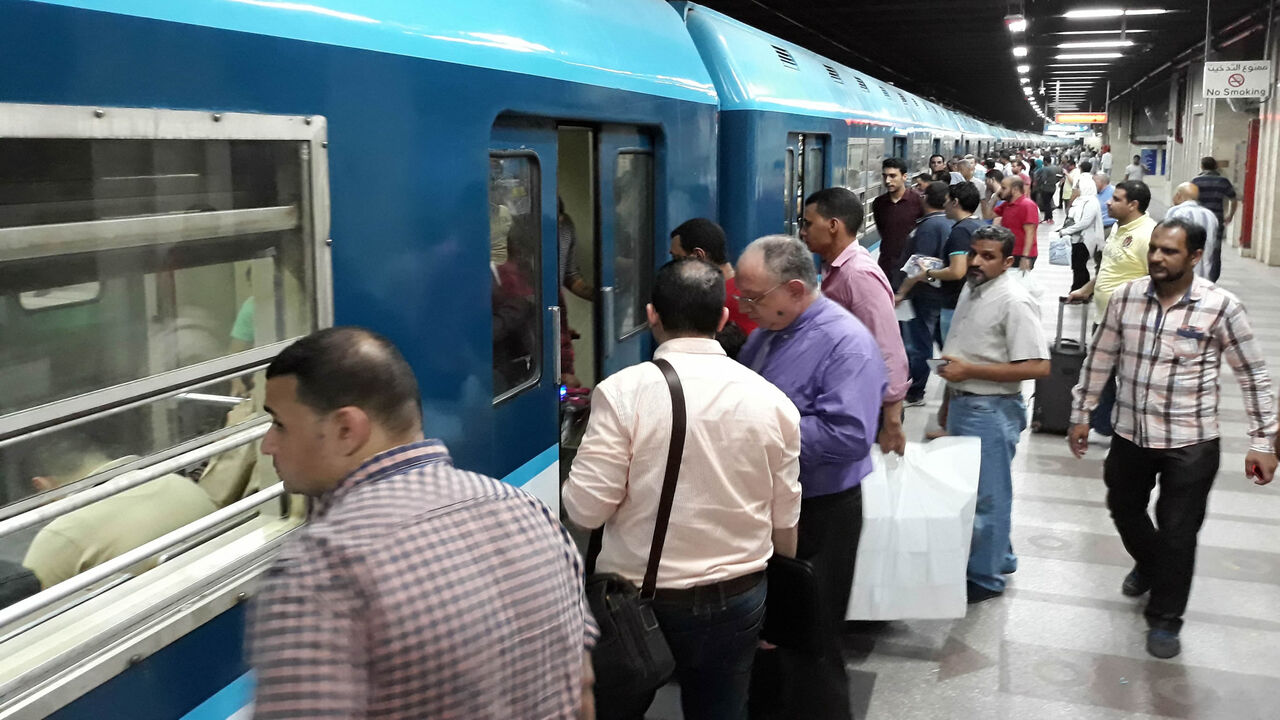 967880622 People queue to get on a train at a metro station in the Egyptian capital, Cairo, on May 28, 2018. - While Egypt's economy is displaying the green shoots of recovery, citizens are imbibing a bitter cocktail of water, fuel, electricity and metro cost hikes. (Photo by KHALED DESOUKI / AFP) (Photo credit should read KHALED DESOUKI/AFP via Getty Images)