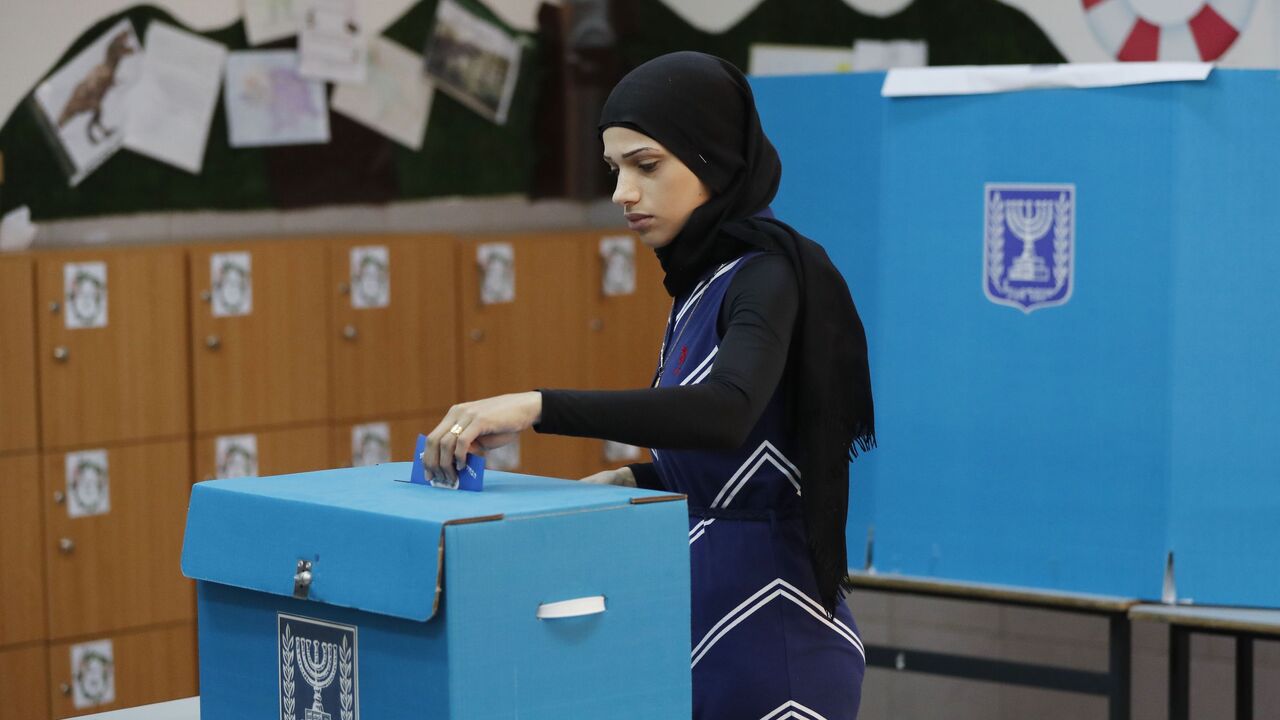 1135871092 An Arab Israeli woman casts her vote during Israel's parliamentary elections on April 9, 2019 at a polling station in the northern Israeli town of Taiyiba. - Israelis voted today in a high-stakes election that will decide whether to extend Prime Minister Benjamin Netanyahu's long right-wing tenure despite corruption allegations or to replace him with an ex-military chief new to politics. (Photo by Ahmad GHARABLI / AFP) (Photo credit should read AHMAD GHARABLI/AFP via Getty Images)