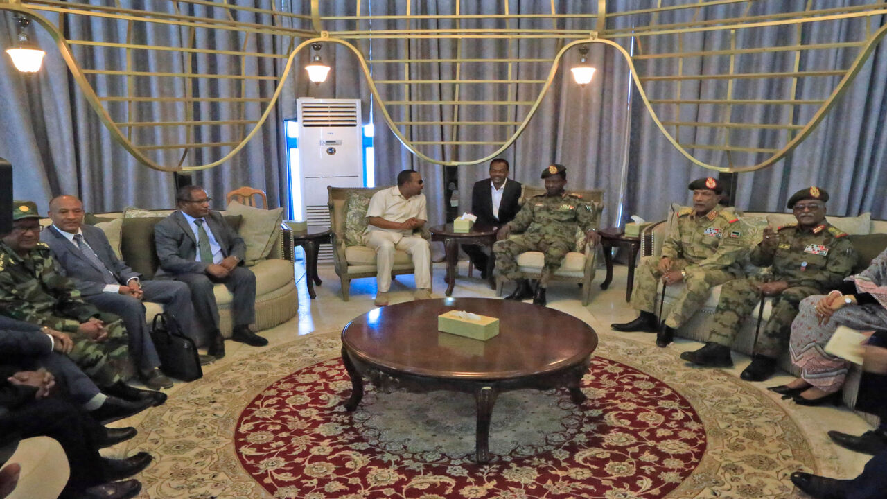 1148451348 Ethiopia's Prime Minister Abiy Ahmed (C-L) meets with members of Sudan's ruling military council after his arrival at Khartoum international airport on June 7, 2019. - Ethiopia's prime minister arrived in Khartoum on June 7, seeking to broker talks between the ruling generals and protesters, as heavily armed paramilitaries remained deployed in some squares of the Sudanese capital after a deadly crackdown, leaving residents in 'terror'. (Photo by ASHRAF SHAZLY / AFP) (Photo credit should read ASHRAF S