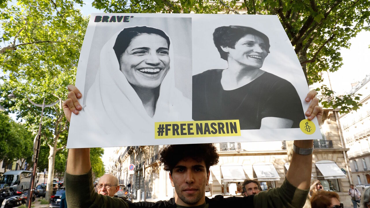 1149689688 People gather outside Iran embassy in France on June 13, 2019 to support Iranian human rights lawyer Nasrin Sotoudeh and demand her release. - Sotoudeh has been sentenced to a total of 33 years in prison over a case with seven charges, but she is to only serve the longest sentence, 12 years imposed for "encouraging corruption and debauchery". She has also been convicted of espionage. Sotoudeh has also been sentenced to a total of 148 lashes for appearing in court without the hijab Islamic head covering and