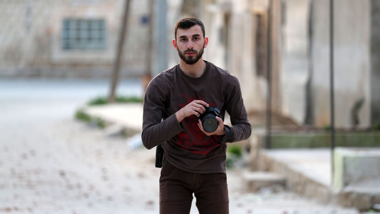1156992820 An image taken on February 25, 2019, shows Syrian citizen journalist Anas al-Dyab posing for a picture in the town of Khan Shaykhun in the southern countryside of the rebel-held Idlib province. - The young citizen journalist was among 11 civilians killed in air raids on Syria's Idlib region Sunday, rescue workers and a monitor said, as he filmed the Russia-backed regime bombardment of the battered enclave. Dyab, a photographer and videographer in his early 20s, was a member of the White Helmets who also con