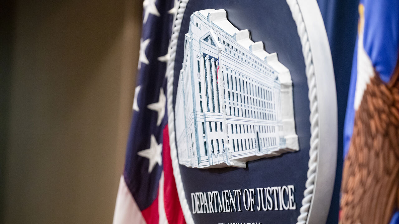 1186593421 WASHINGTON, DC - DECEMBER 05: The U.S. Department of Justice seal on the stage where U.S. and U.K. Law enforcement officials will announce warrants for the arrests of Maksim Viktorovich Yakubets and Igor Olegovich Turashev, two Russian hackers associated with a group called Evil Corp., at the U.S. Department of Justice on December 5, 2019 in Washington, DC. Today the U.S. Department of Justice, Federal Bureau of Investigations (FBI), and the U.S. Treasury Department’s Office of Foreign Assets Control (OFAC)