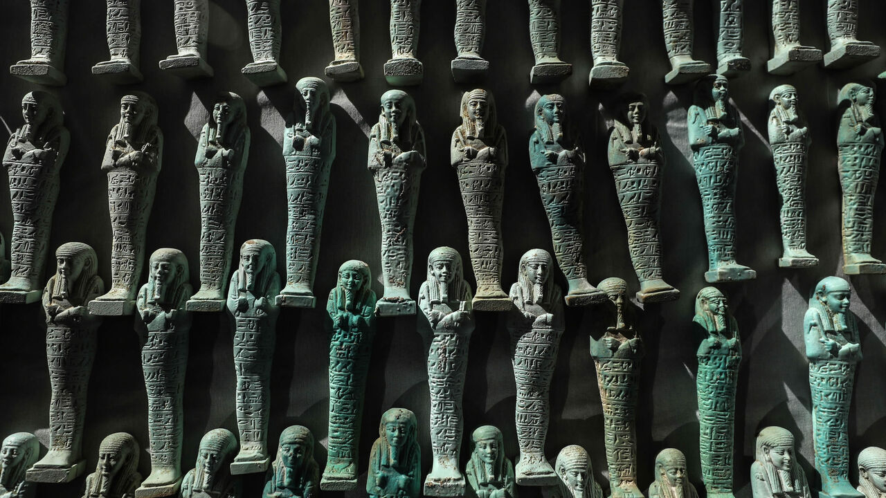 1197622532 A picture taken on January 30, 2020, shows a collection of Ushabtis or funerary figurines discovered among many archeological finds in 3000-year-old communal tombs dedicated to high priests, in Al-Ghoreifa in Tuna al-Jabal in the Minya governorate. - Egypt's antiquities ministry unveiled 16 tombs of ancient high priests containing 20 sarcophagi, including one dedicated to the sky god Horus, discovered at the archaeological site, about 300 kilometres (186 miles) south of Cairo. The shared tombs were dedicate