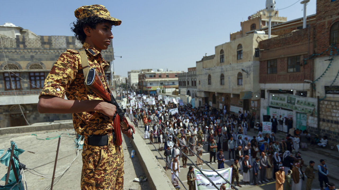 1228507711 A fighter loyal to Yemen's Huthi rebels stands guard during a rally commemorating the death of Shiite Imam Zaid bin Ali in the capital Sanaa, on September 14, 2020. (Photo by Mohammed HUWAIS / AFP) (Photo by MOHAMMED HUWAIS/AFP via Getty Images)
