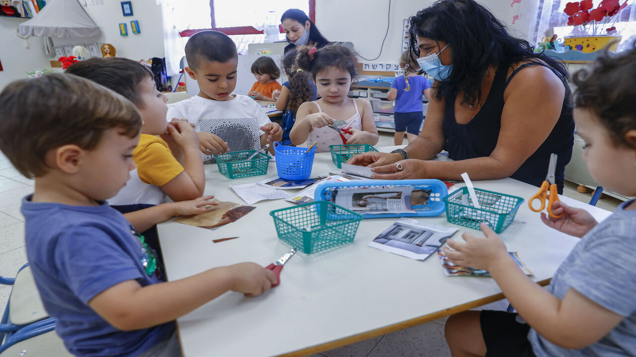 1229143854 Israeli children take part in activities at a kindergarten in the central city of Shoham, on October 18, 2020. - Israel started cautiously emerging from a second coronavirus lockdown after a month of tight restrictions, with the re-opening of preschools, kindergartens, beaches and national parks, as numbers of new infections recede. (Photo by JACK GUEZ / AFP) (Photo by JACK GUEZ/AFP via Getty Images)