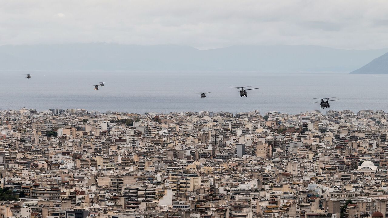 1229323985 Hellenic Air Force helicopters fly over buildings in Athens on October 28, 2020, during celebrations marking Greece's National "Oxi" (No) Day, commemorating Greece's refusal to accept the ultimatum advanced by fascist Italy in 1940 during World War II. (Photo by Angelos Tzortzinis / AFP) (Photo by ANGELOS TZORTZINIS/AFP via Getty Images)